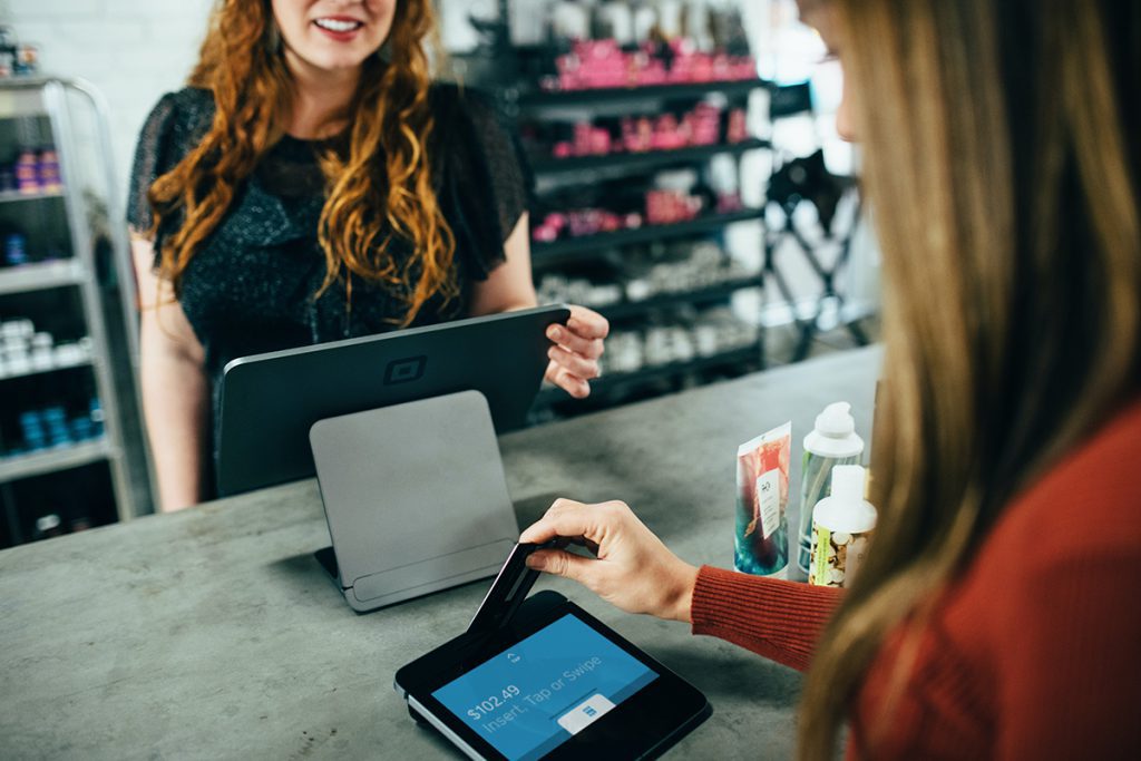 woman pays with loyalty card