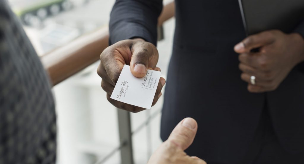 man hands out business card