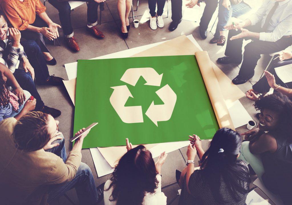 group discussion gathered round recycling poster