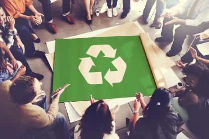 group discussion gathered round recycling poster