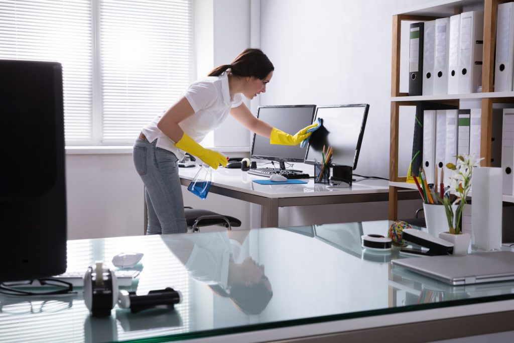 woman cleaning her workspace